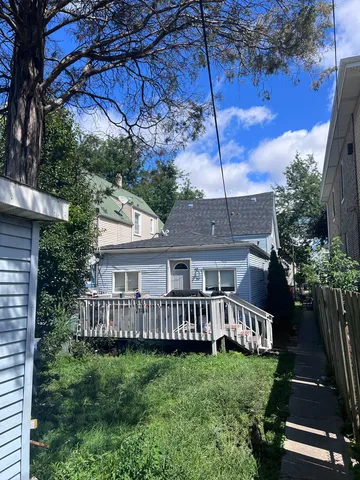 a view of backyard with a deck and a garden