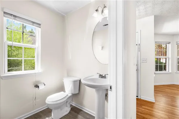 a bathroom with a toilet sink and mirror