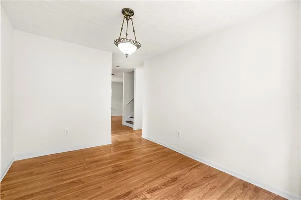 a view of a room with wooden floor and sink