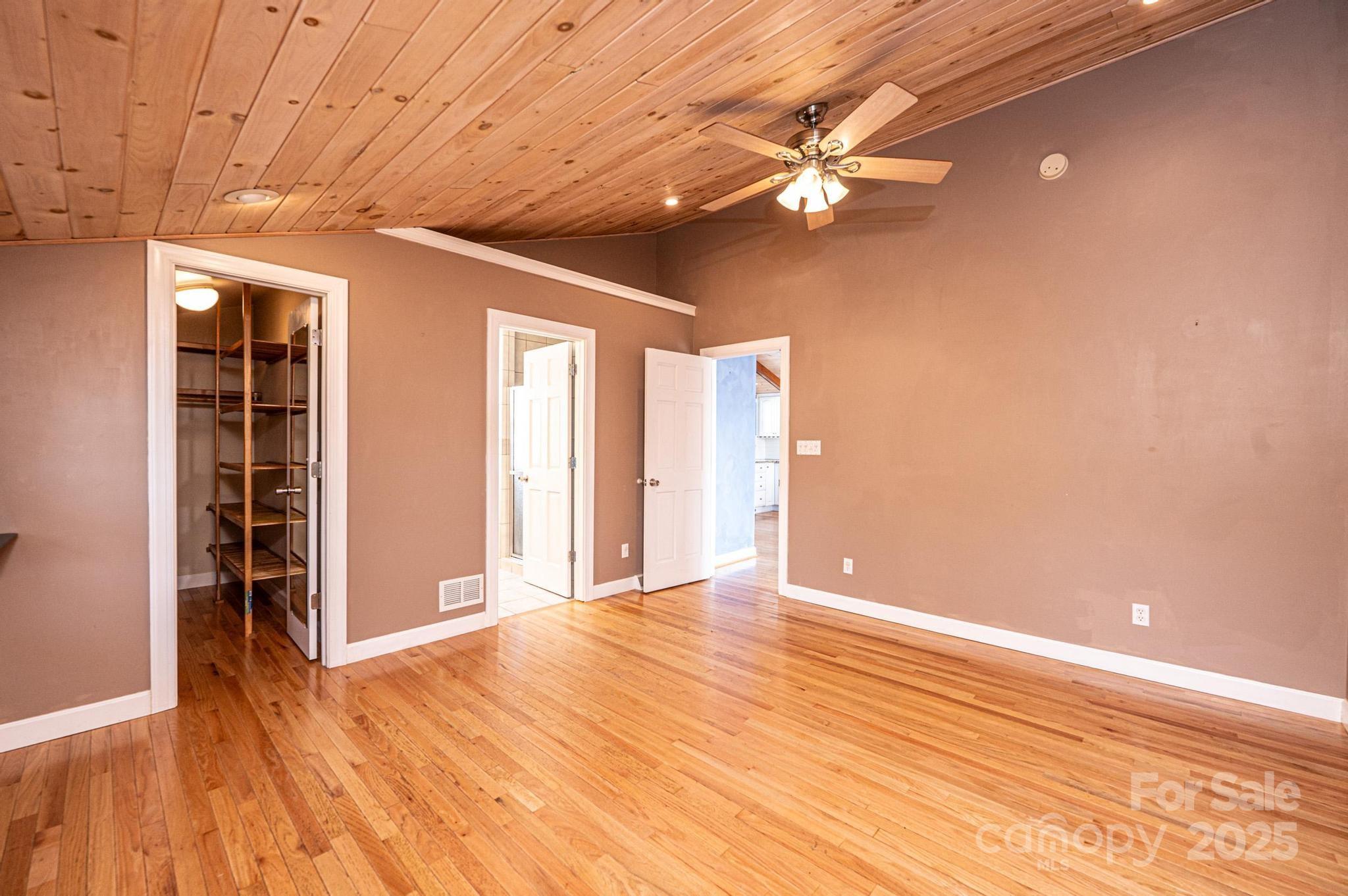 4846 Midway Sand Road Hickory, NC 28601 - Photo 30 of 48 en empty room with wooden floor fan and windows