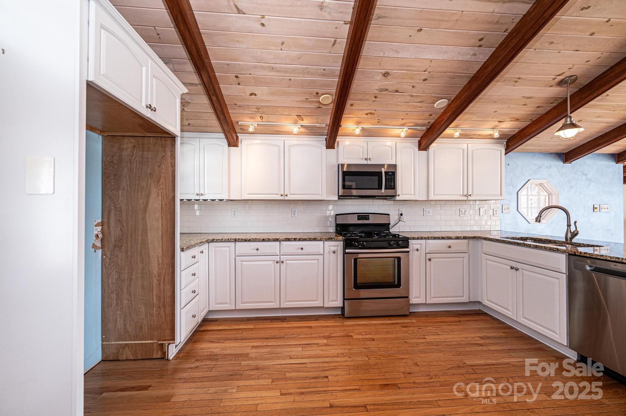 4846 Midway Sand Road Hickory, NC 28601 - Photo 6 of 48 a kitchen with stainless steel appliances granite countertop a stove a sink and a microwave