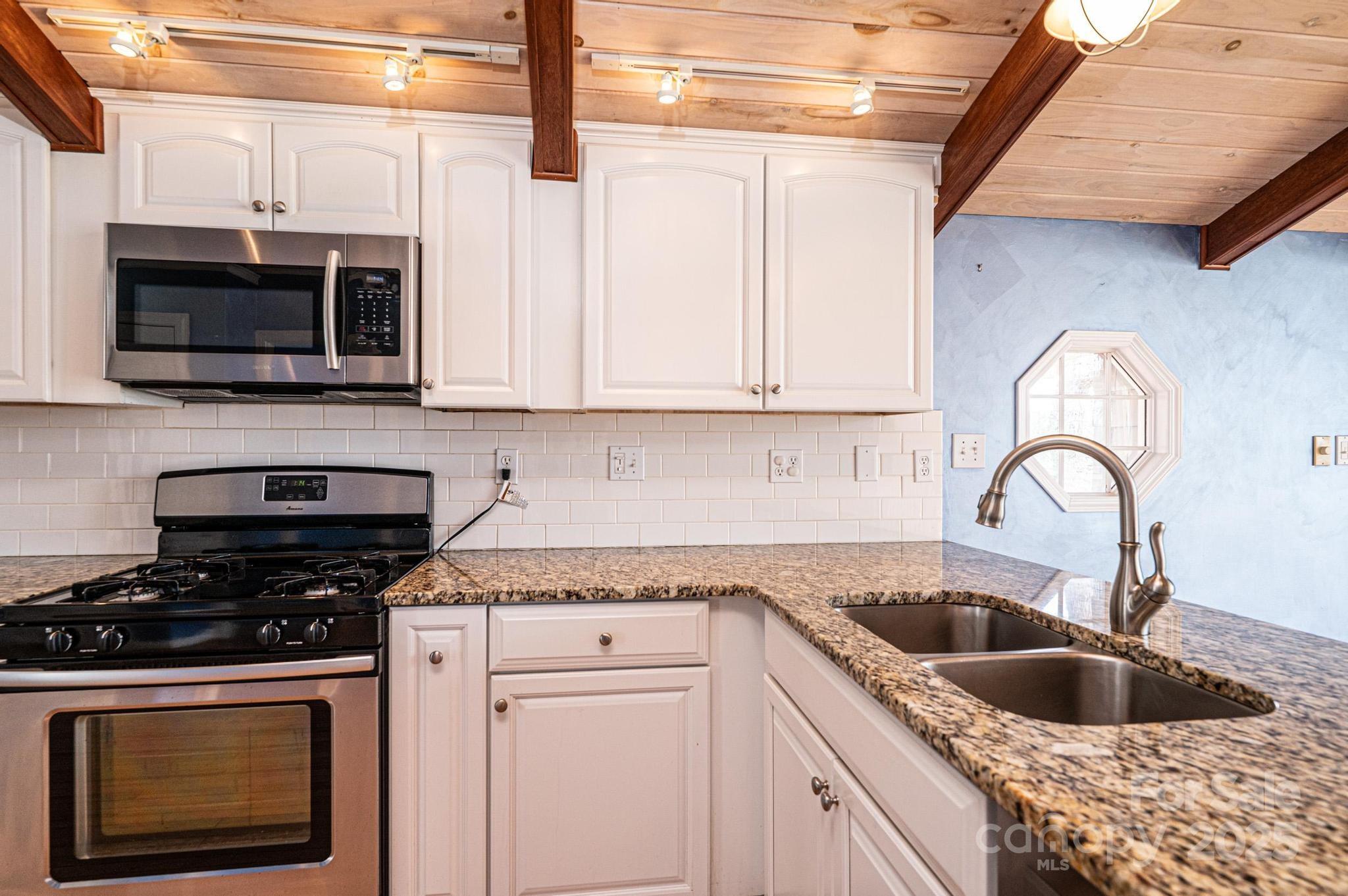 4846 Midway Sand Road Hickory, NC 28601 - Photo 8 of 48 a kitchen with stainless steel appliances granite countertop a sink a stove a microwave and wooden cabinets
