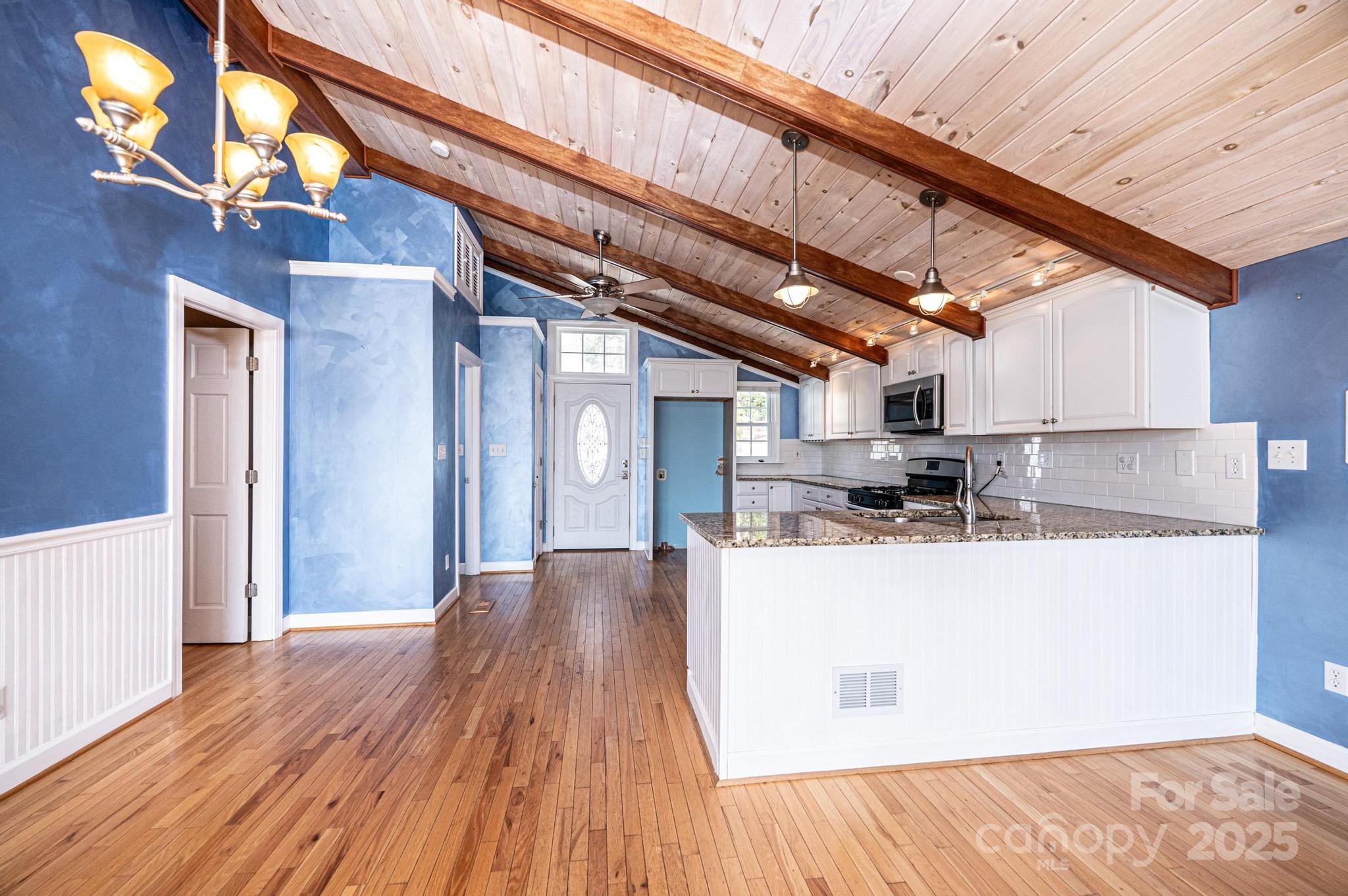 4846 Midway Sand Road Hickory, NC 28601 - Photo 9 of 48 a view of a kitchen with kitchen island a sink wooden floor and stainless steel appliances