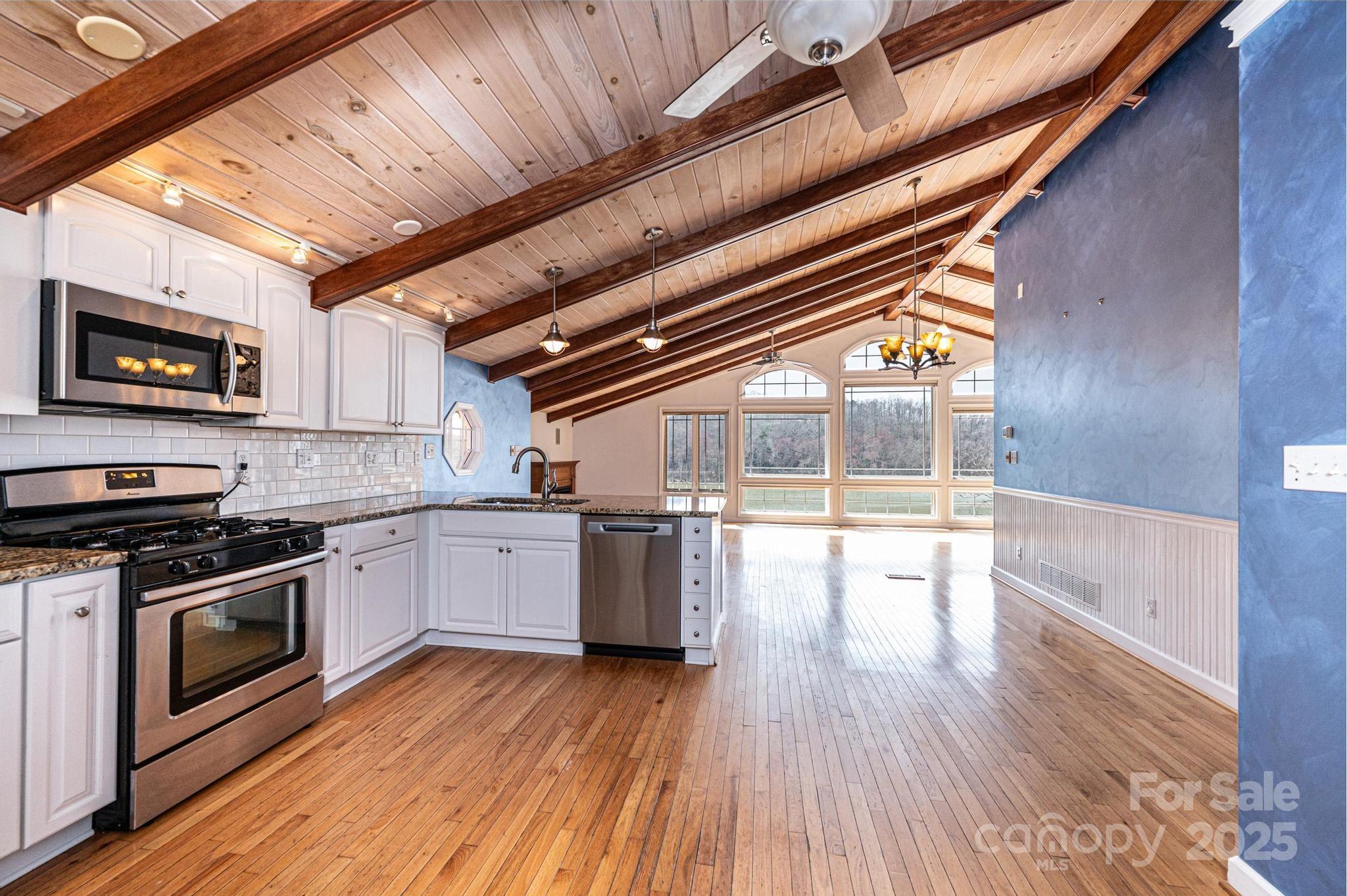 4846 Midway Sand Road Hickory, NC 28601 - Photo 10 of 48 a kitchen with a wooden floors and stainless steel appliances