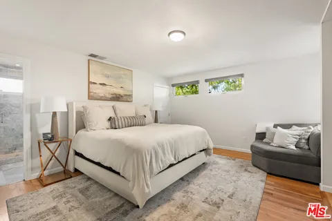 a bedroom with a bed and a couch
