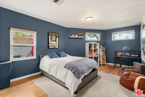 a bedroom with a bed and dresser