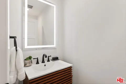 a bathroom with a sink vanity and a mirror