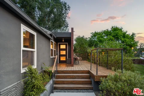 a view of a house with backyard and deck