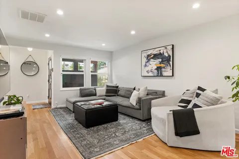 a living room with furniture rug and window