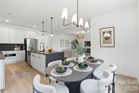 a large kitchen with a table and chairs