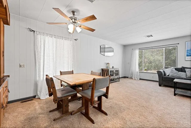 a view of a livingroom with furniture and a window