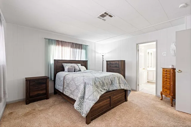 a bedroom with a bed and dresser