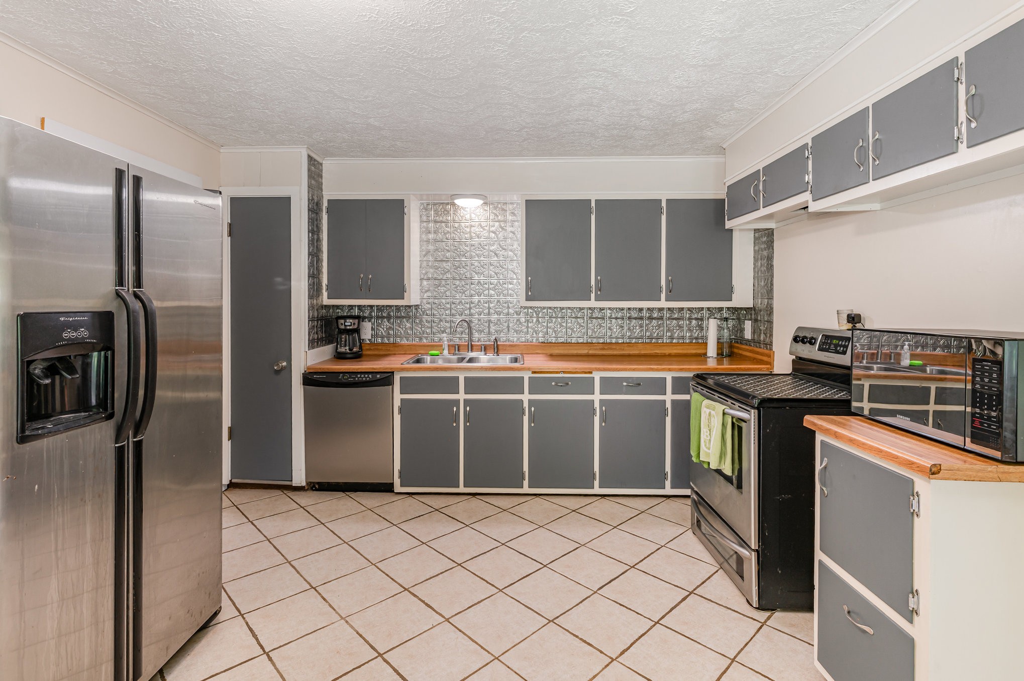 999 Stewart Road Dickson, TN 37055 - Photo 14 of 32 a kitchen with stainless steel appliances a refrigerator and a stove top oven