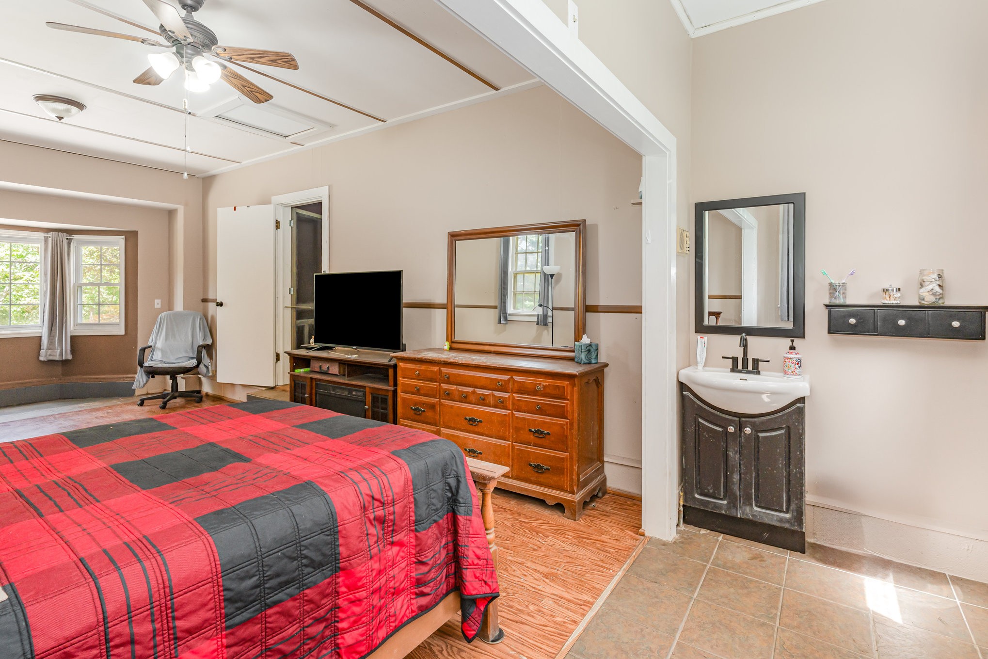 999 Stewart Road Dickson, TN 37055 - Photo 17 of 32 a bedroom with a bed a mirror and a flat tv screen on dresser