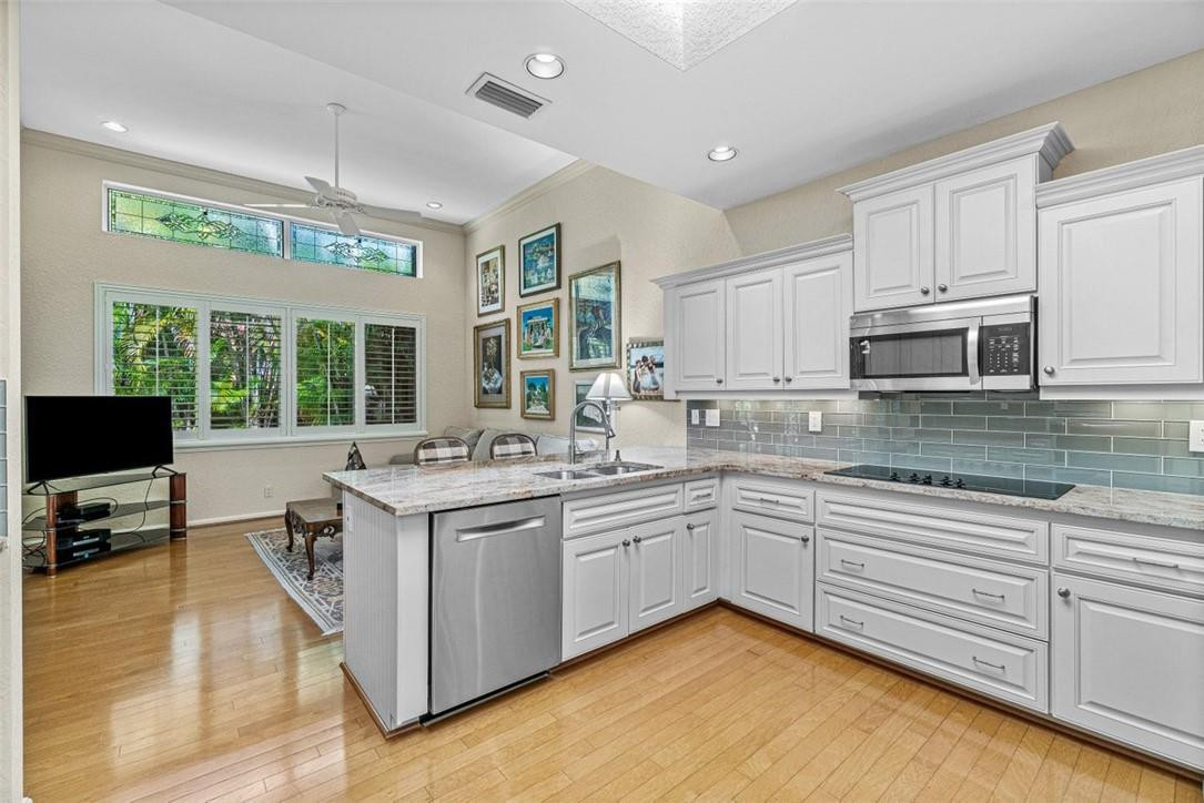 6500 Via Rosa Boca Raton, FL 33433 - Photo 13 of 31 a kitchen with stainless steel appliances granite countertop a sink and cabinets