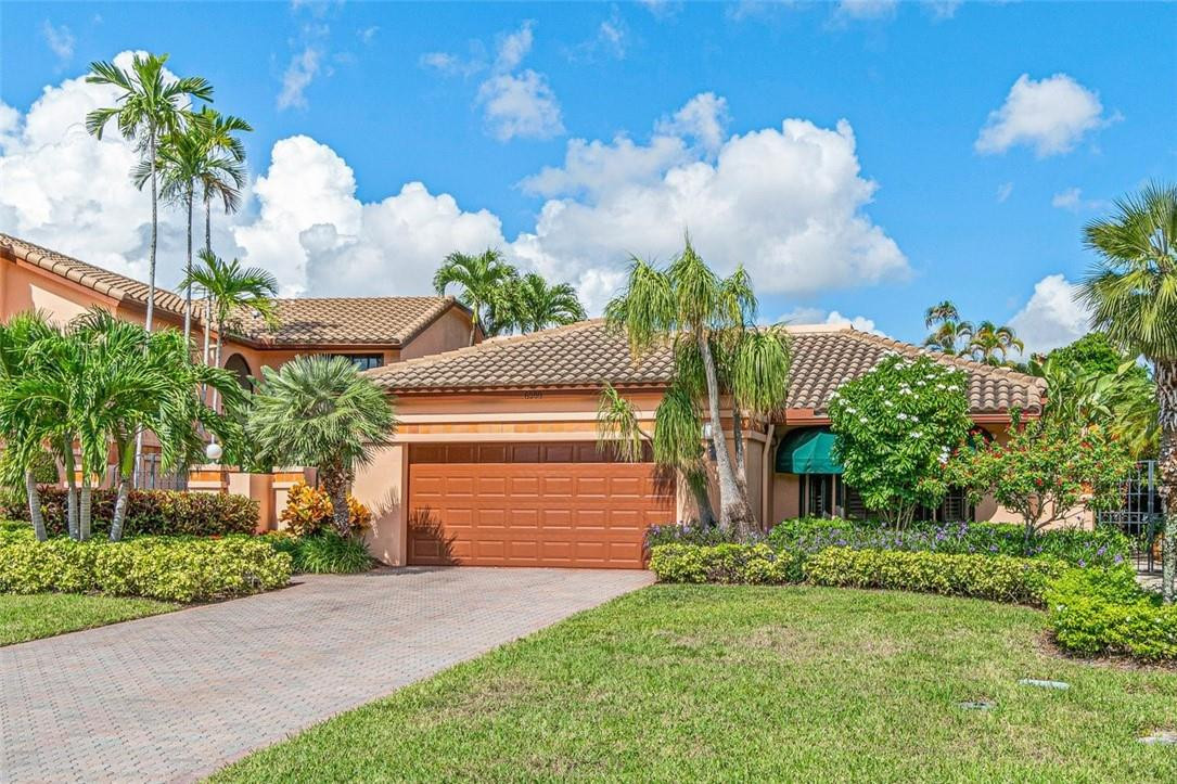 6500 Via Rosa Boca Raton, FL 33433 - Photo 3 of 31 a front view of a house with a yard and garage
