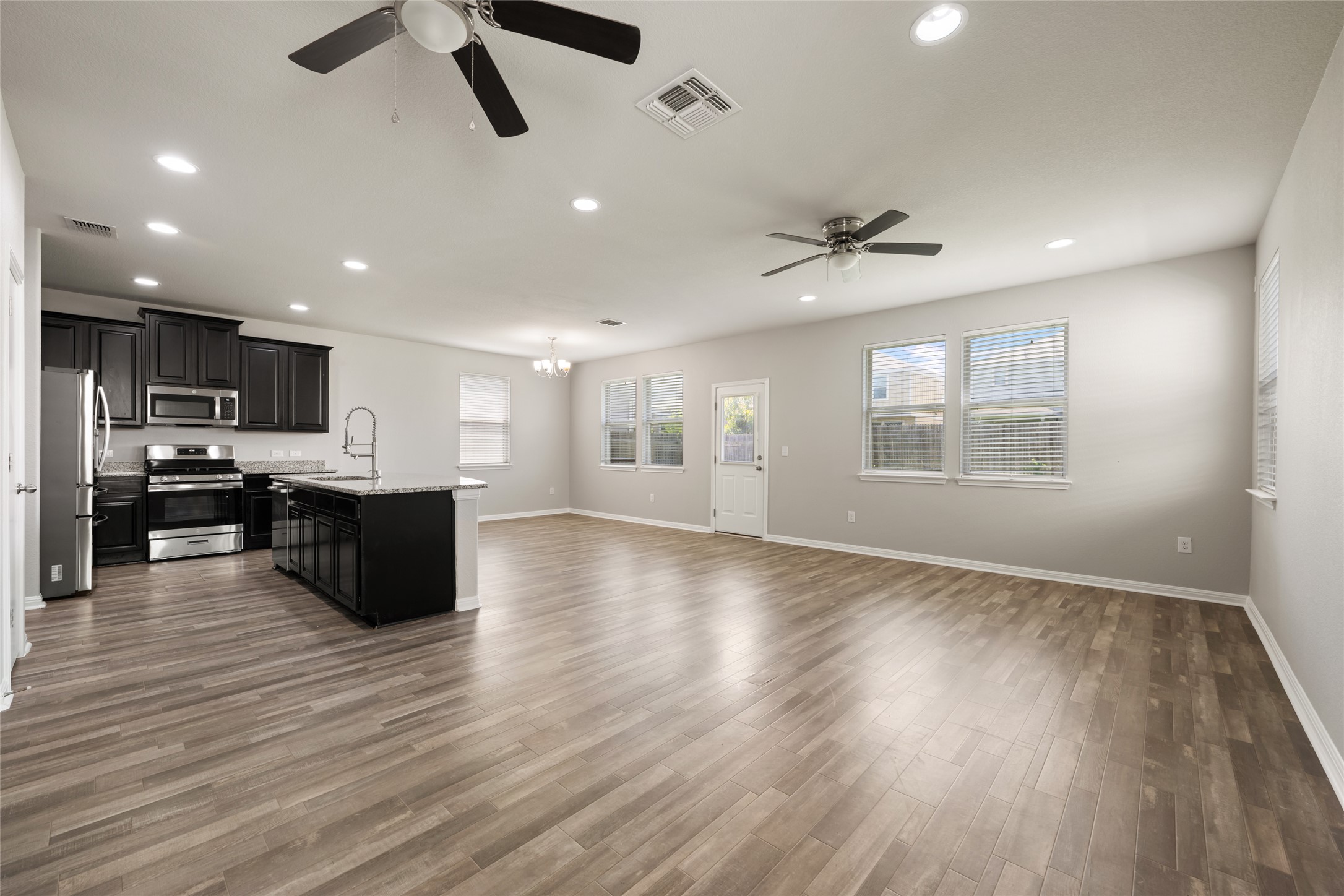 An open concept living area seamlessly connects the kitchen and dining spaces, offering generous natural light.