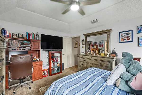 a bedroom with furniture and a flat screen tv