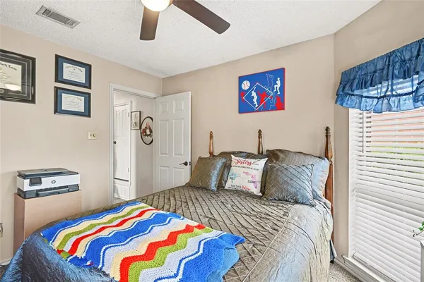 a bedroom with bed and wooden floor