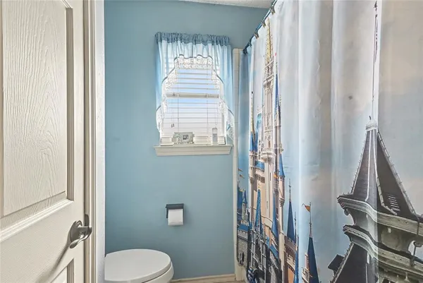 a bathroom with a toilet a sink and a mirror