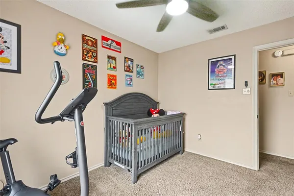 a view of a hallway with a baby crib