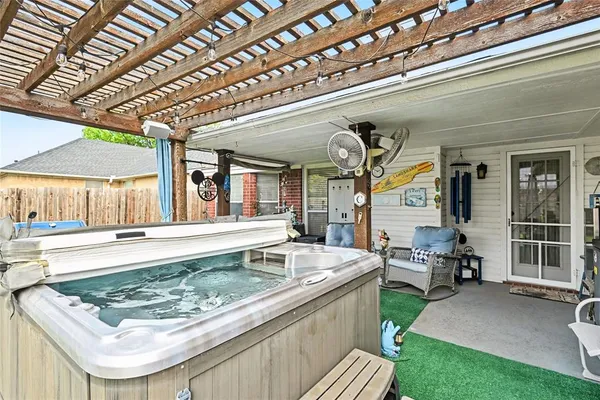 a view of a patio with a table and chairs