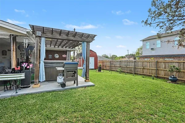 a view of a chair and table in backyard of the house