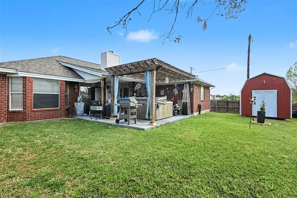a view of a house with backyard porch and sitting area