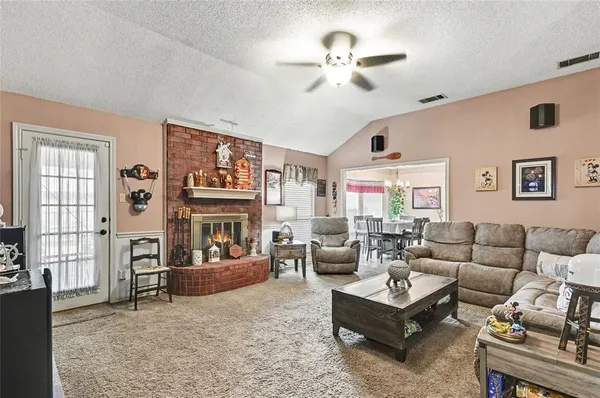 a living room with fireplace furniture and a window
