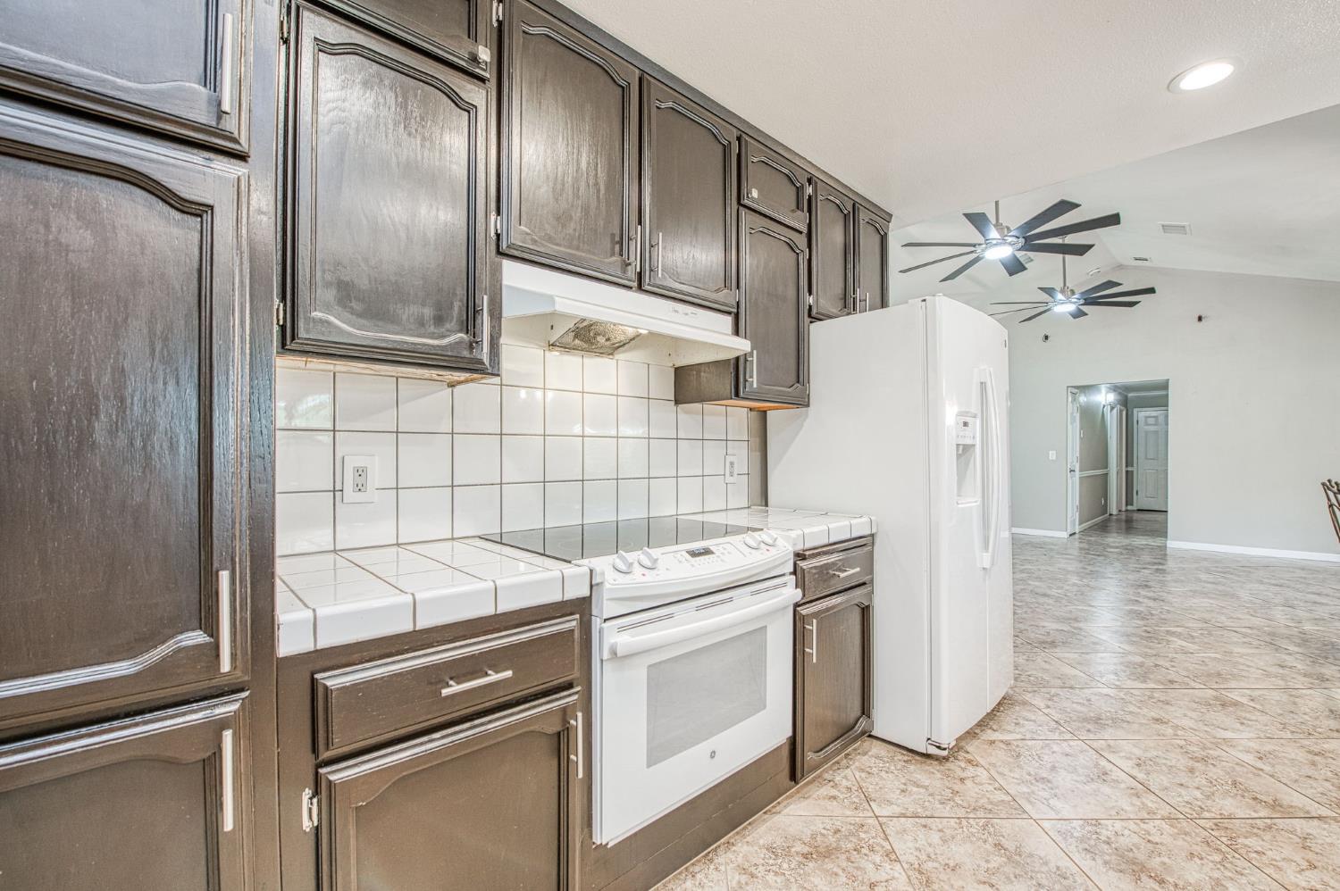 33717 River Knolls Road Coarsegold, CA 93614 - Photo 12 of 66 a kitchen with a refrigerator sink and cabinets