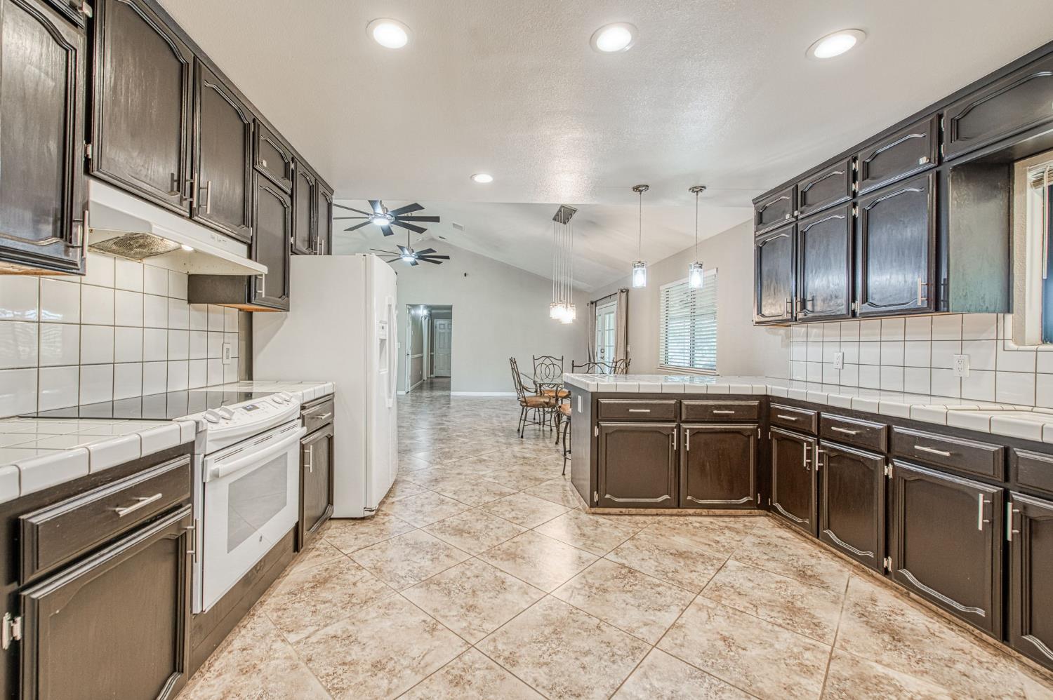 33717 River Knolls Road Coarsegold, CA 93614 - Photo 13 of 66 a large kitchen with stainless steel appliances granite countertop a sink stove and refrigerator