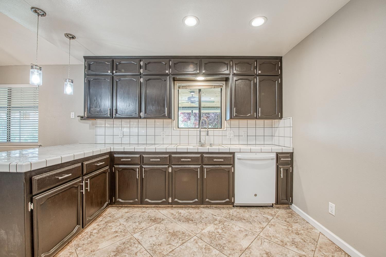 33717 River Knolls Road Coarsegold, CA 93614 - Photo 14 of 66 a kitchen with stainless steel appliances granite countertop a sink and stove top oven