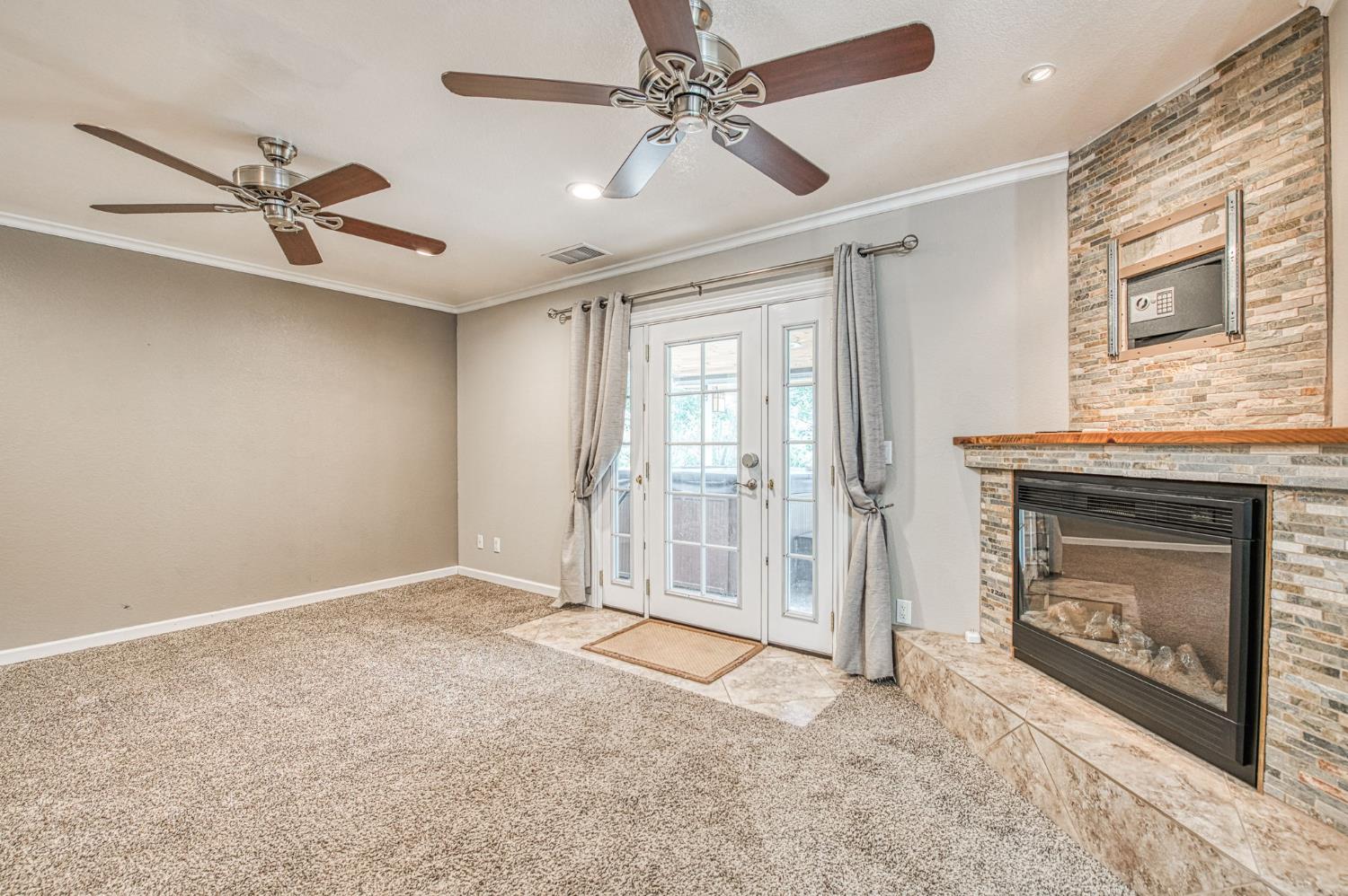 33717 River Knolls Road Coarsegold, CA 93614 - Photo 20 of 66 a view of an empty room with a fireplace and a window