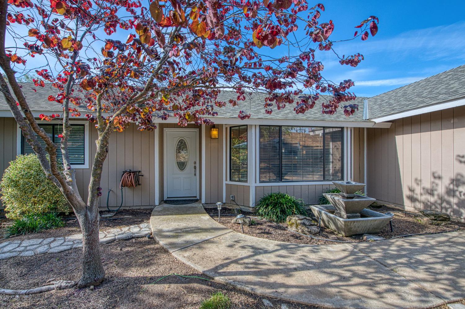 33717 River Knolls Road Coarsegold, CA 93614 - Photo 2 of 66 a front view of a house with garden