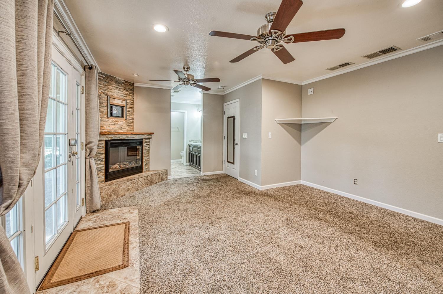 33717 River Knolls Road Coarsegold, CA 93614 - Photo 22 of 66 en empty room with windows and fireplace