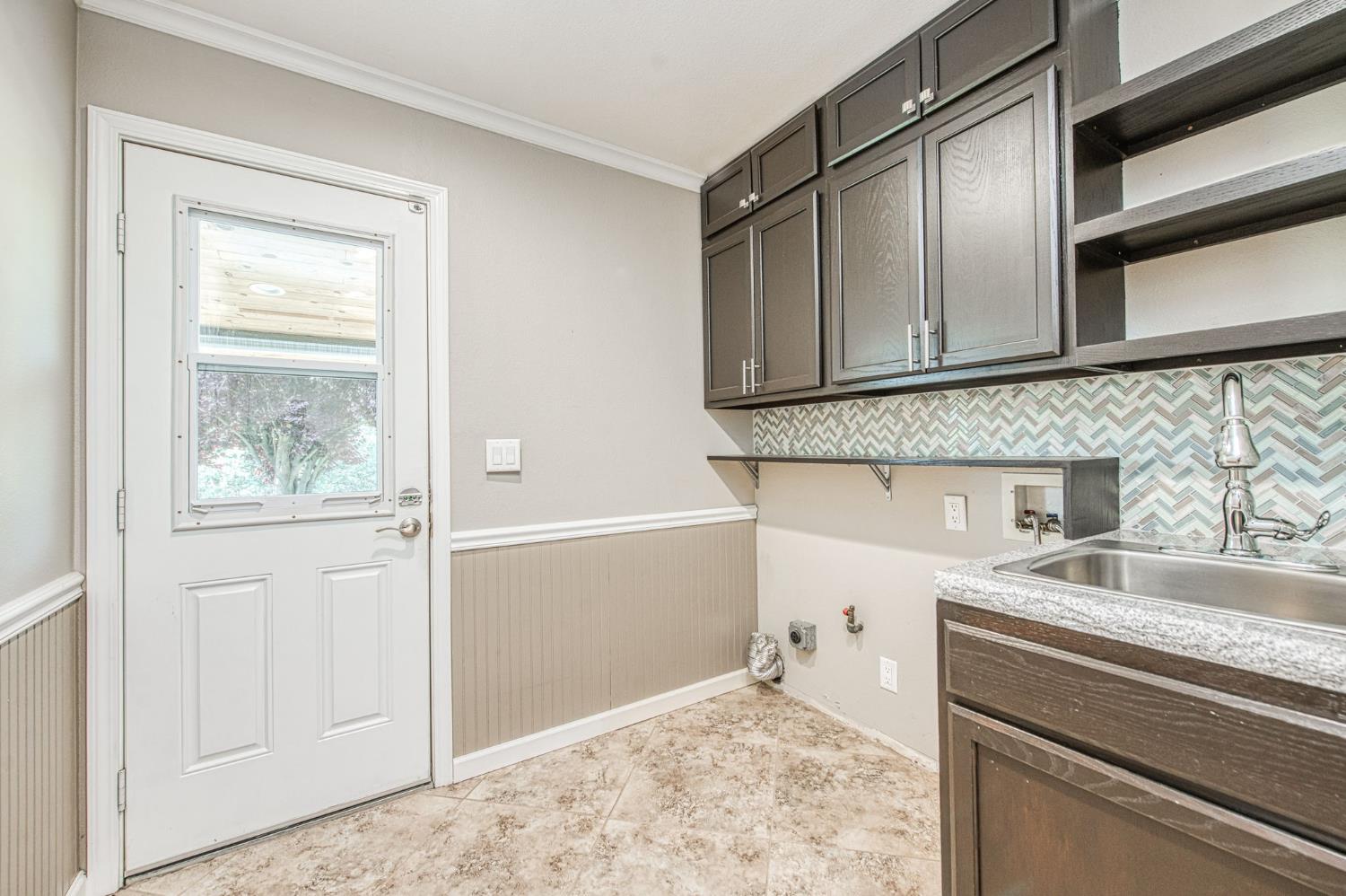 33717 River Knolls Road Coarsegold, CA 93614 - Photo 24 of 66 a kitchen with a sink refrigerator and cabinets