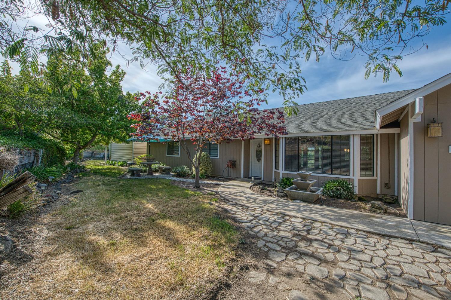 33717 River Knolls Road Coarsegold, CA 93614 - Photo 4 of 66 a front view of a house with a garden