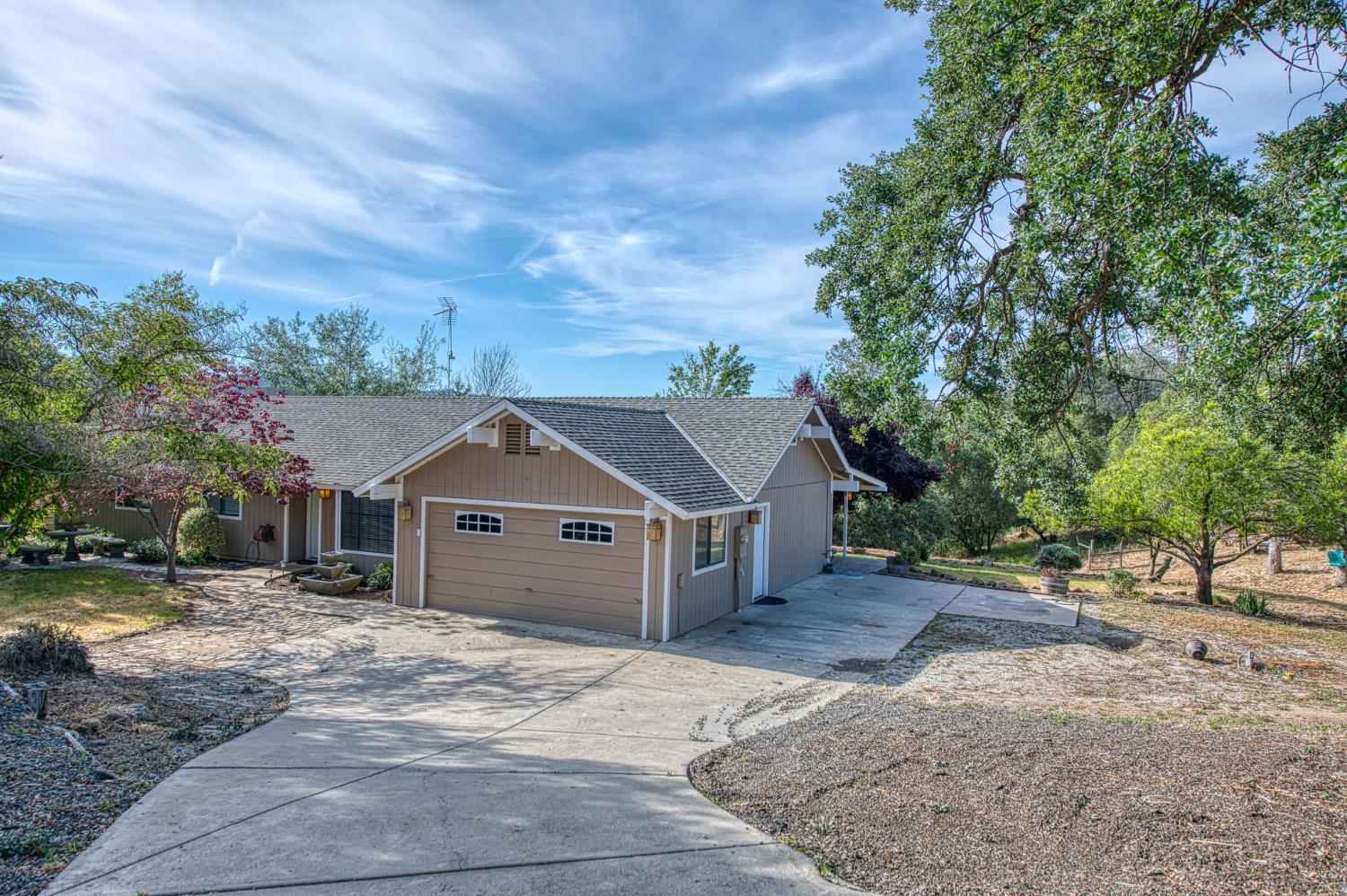 33717 River Knolls Road Coarsegold, CA 93614 - Photo 46 of 66 a front view of a house with a yard