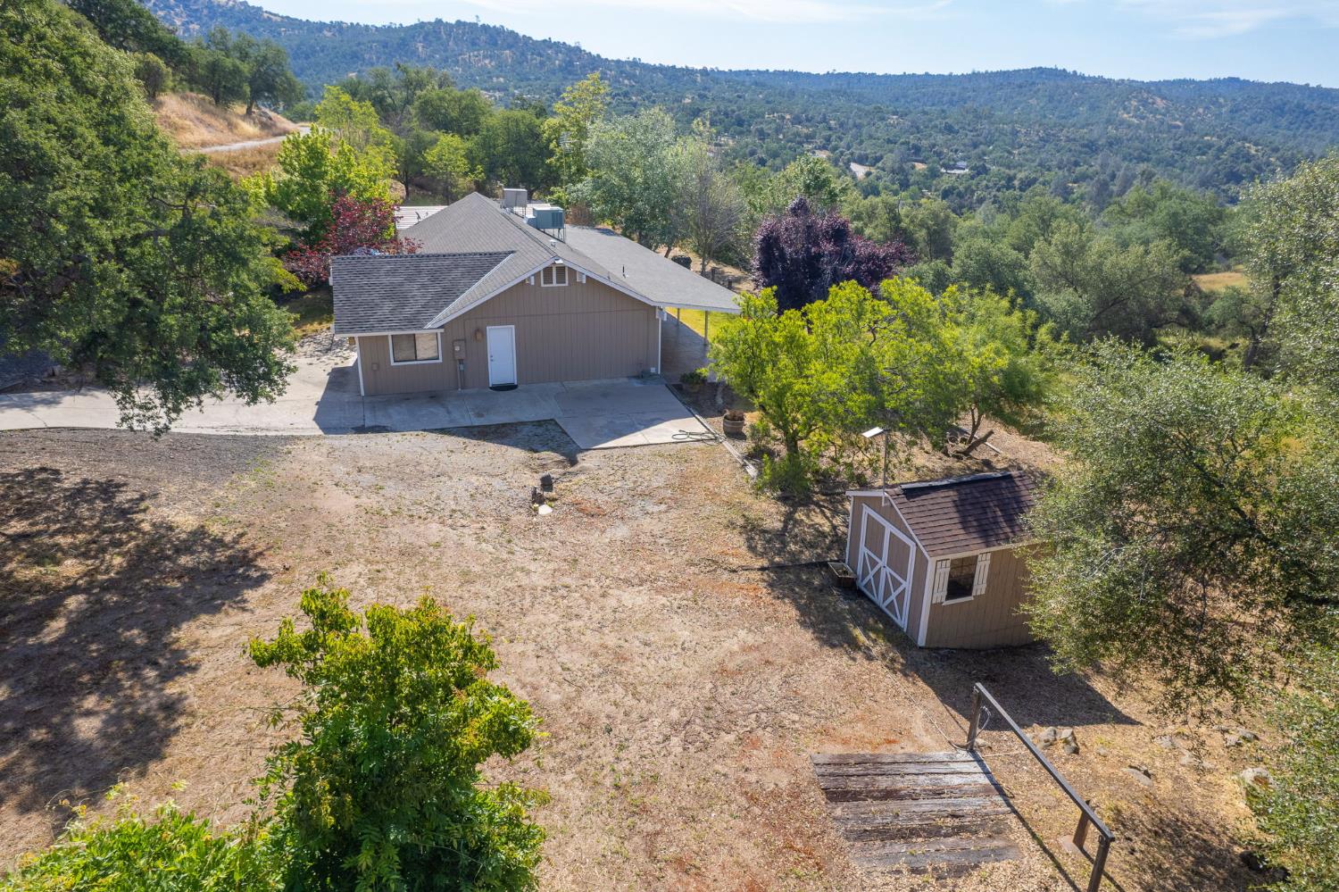 33717 River Knolls Road Coarsegold, CA 93614 - Photo 60 of 66 a view of a house with a mountain yard