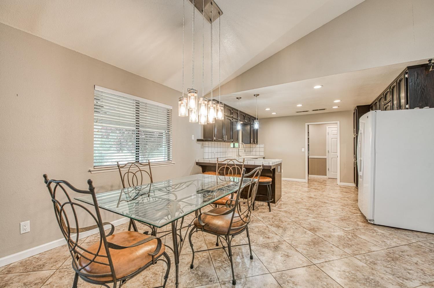 33717 River Knolls Road Coarsegold, CA 93614 - Photo 10 of 66 a dining room with furniture and a large window