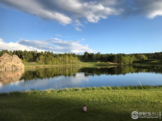 a view of a lake with houses in the back