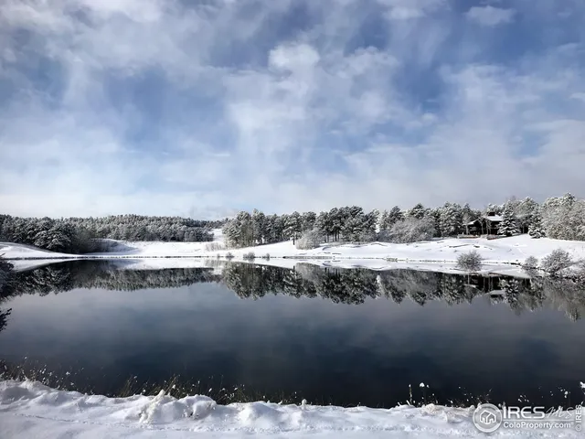 a view of a lake with houses in the back