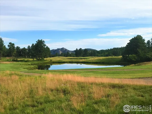 a view of a lake with a house in the background