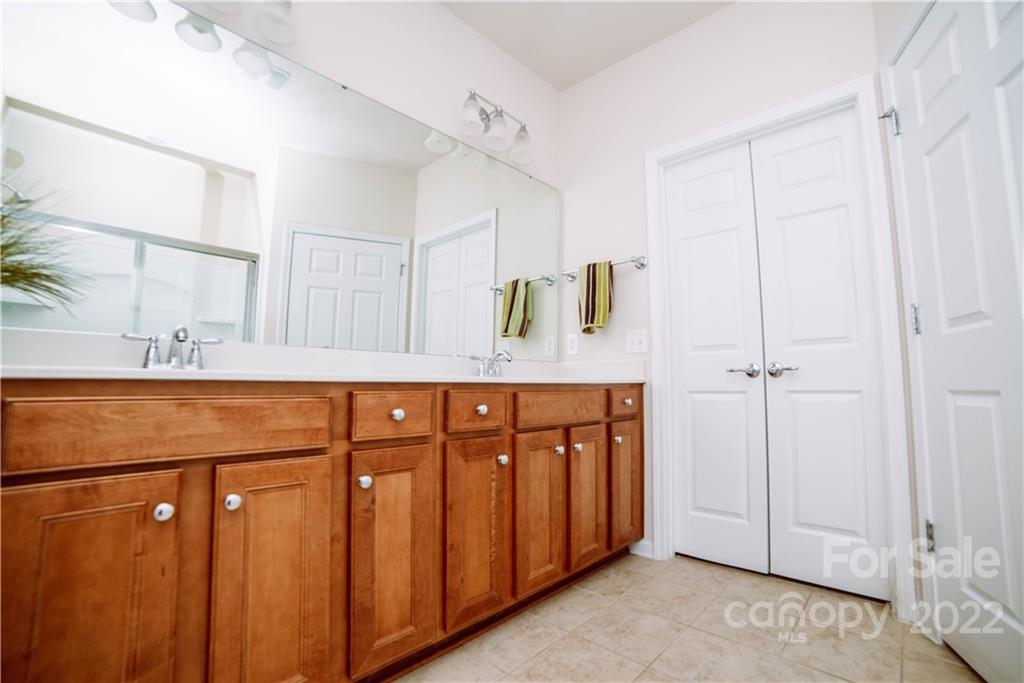 9005 Smokey Hill Road Indian Land, SC 29707 - Photo 16 of 30 a bathroom with a sink a mirror and a shower