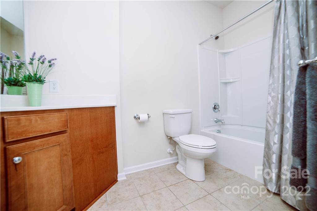 9005 Smokey Hill Road Indian Land, SC 29707 - Photo 24 of 30 a bathroom with a toilet a sink and shower