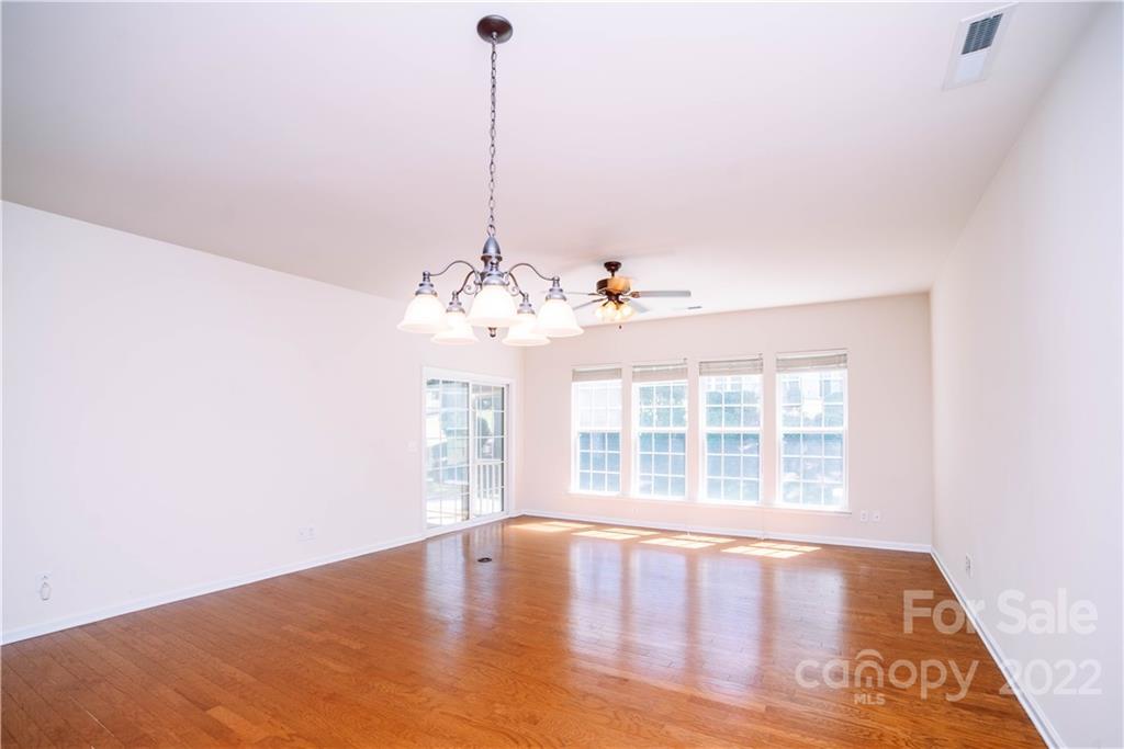 9005 Smokey Hill Road Indian Land, SC 29707 - Photo 8 of 30 a view of a livingroom with a chandelier wooden floor and windows