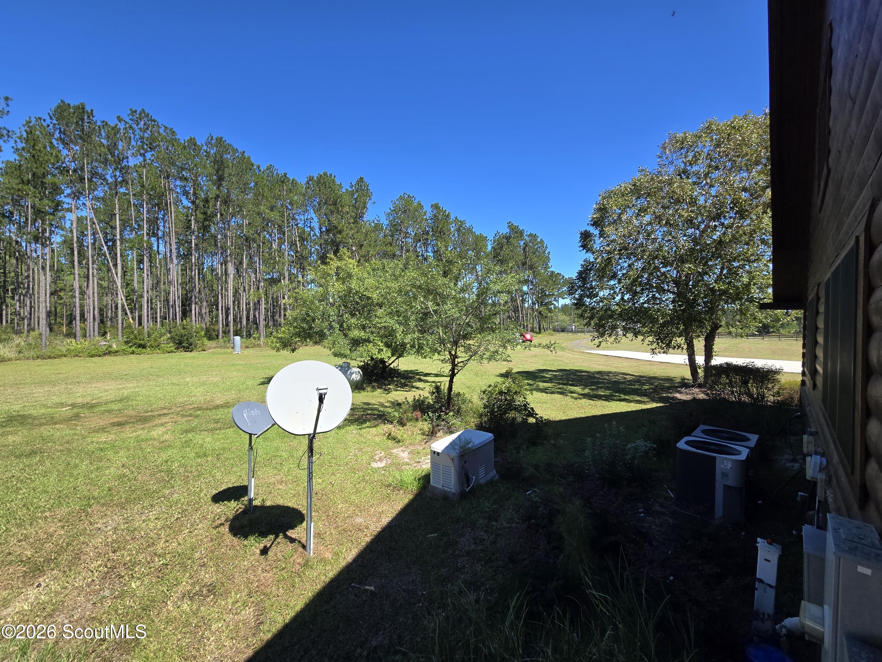 115 Farms Edge Road Manor, GA 31550 - Photo 74 of 78 View from back, left side of home of Generac generator, 2 HVACS, satellites, and propane tank
