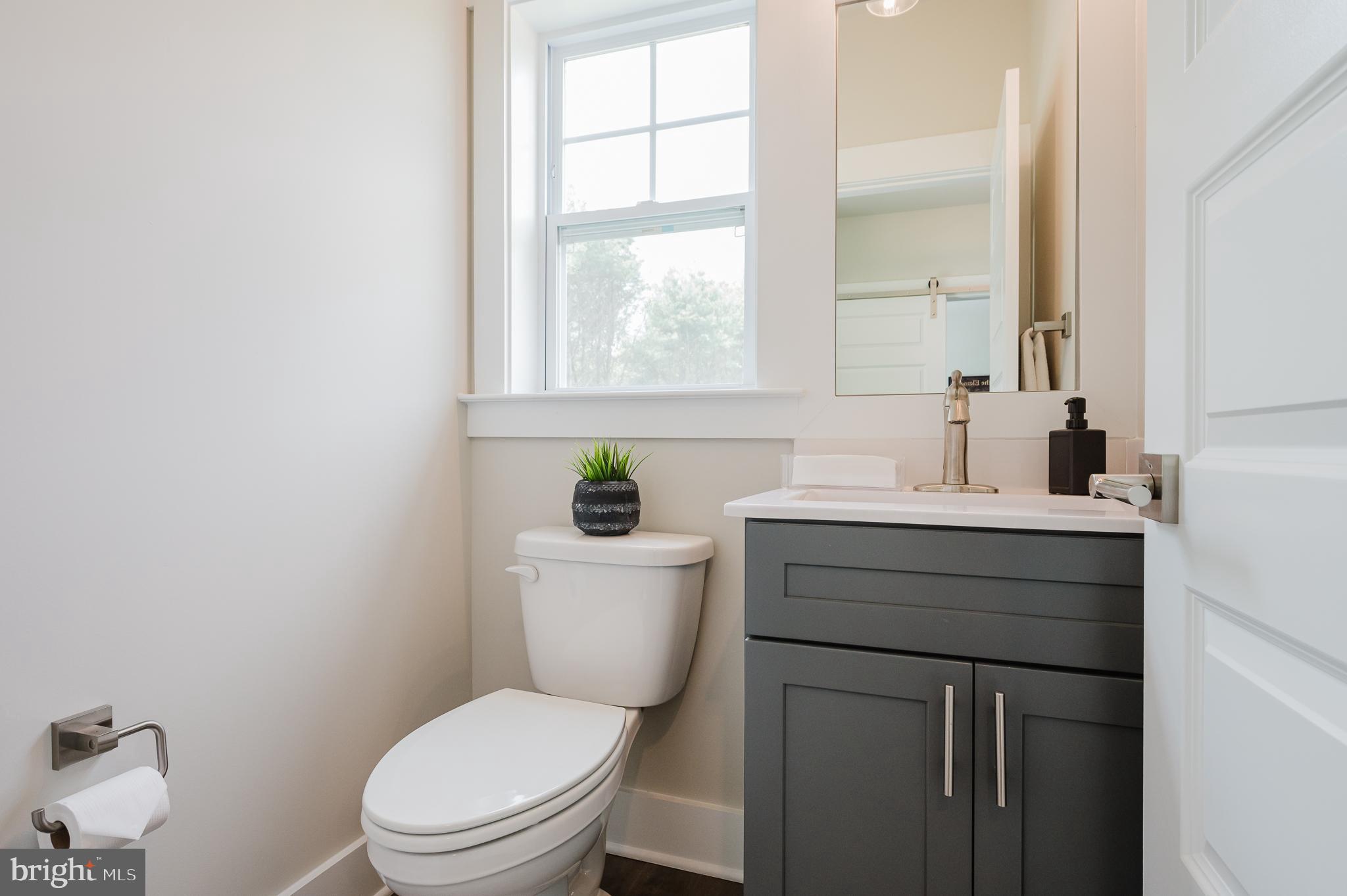 2647 Hoopes Road Forest Hill, MD 21050 - Photo 14 of 29 a bathroom with a toilet a sink a vanity a window and mirror