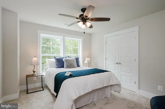 a bedroom with a large bed and a chandelier