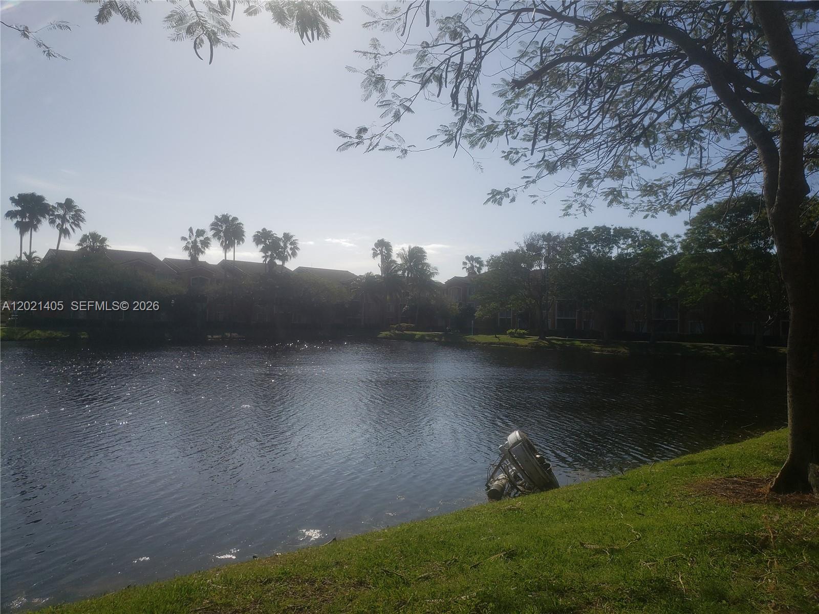 3870 Lyons Road, Unit 2098 Pompano Beach, FL 33073 - Photo 4 of 31 a view of a lake in between two of trees
